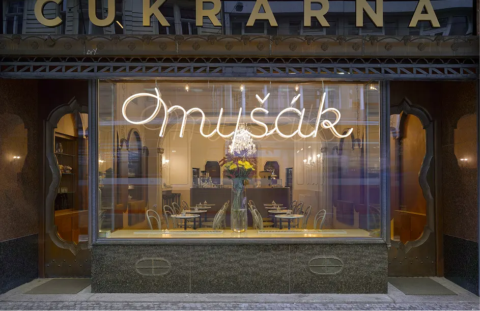 Shop window of Myšák pastry shop with neon sign on Vodičkova Street.